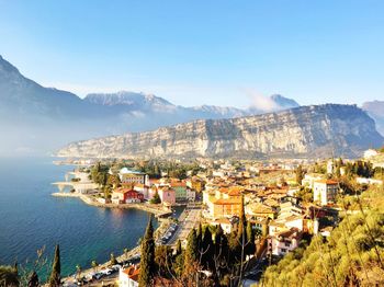 High angle view of townscape by mountain against sky