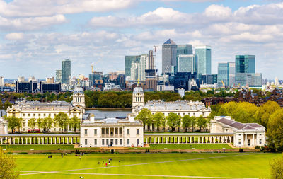 Buildings in city against cloudy sky