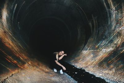 Portrait of girl sitting in tunnel