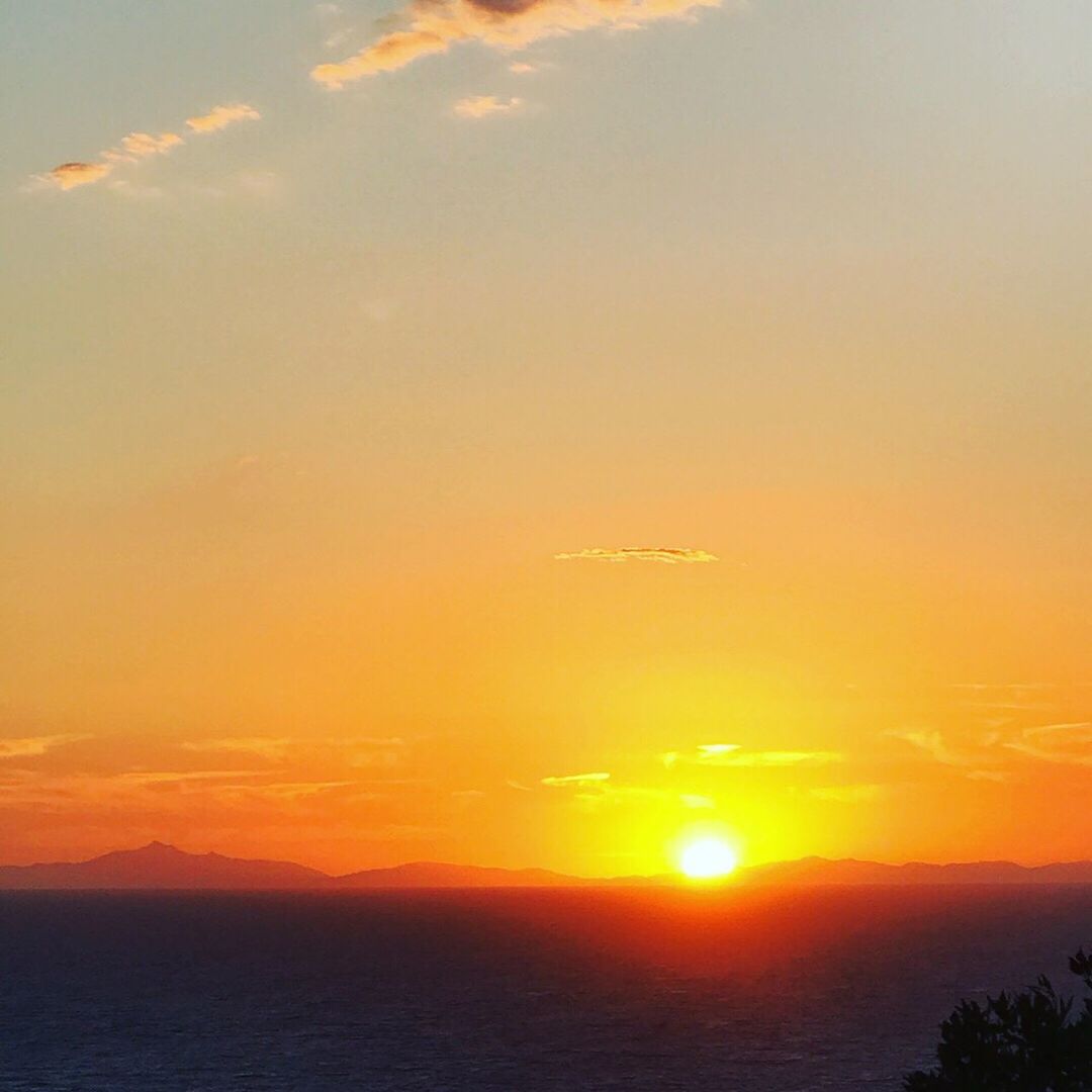 SCENIC VIEW OF SUNSET OVER SEA