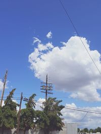 Low angle view of power lines against blue sky