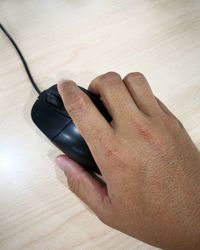 High angle view of person hand on table