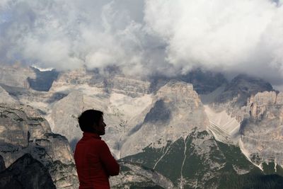 Rear view of man looking at mountain range