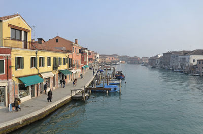 Panoramic view of people in city against clear sky