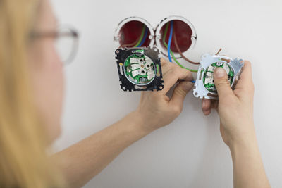 Female electrician renovating house