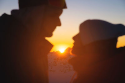 Couple portrait, silhouette of lovers looking at each other and smiling, against the backdrop of the