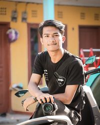 Portrait of young man sitting in bus