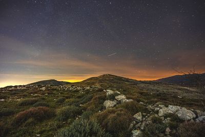 Scenic view of mountains against sky at night