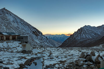 Scenic view of snowcapped mountains against clear sky during winter