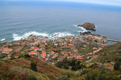 High angle view of townscape by sea