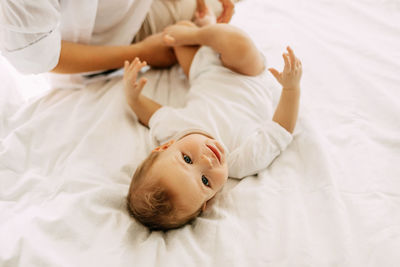 High angle view of boy lying on bed