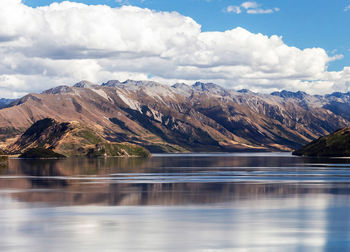 Scenic view of lake and mountains against sky