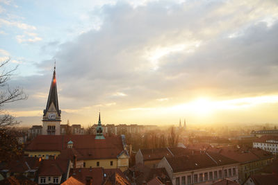 View of cityscape against cloudy sky
