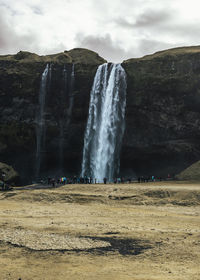 Scenic view of waterfall against sky