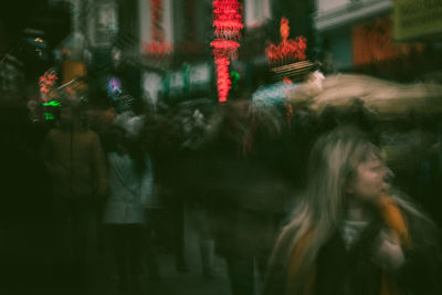 People walking on street in city at night