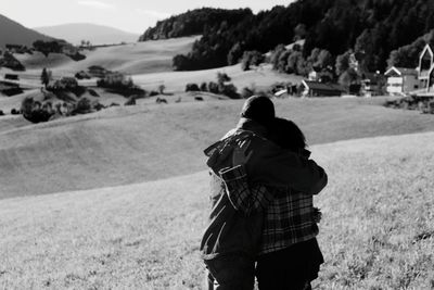 Couple embracing while standing at farm