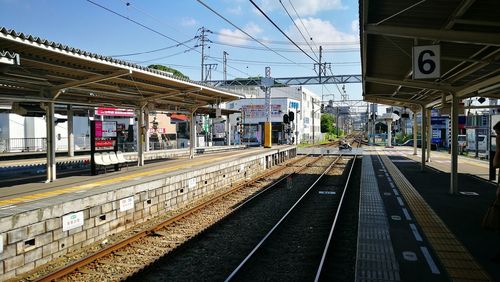 Train at railroad station against sky