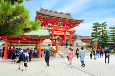 People at temple against sky