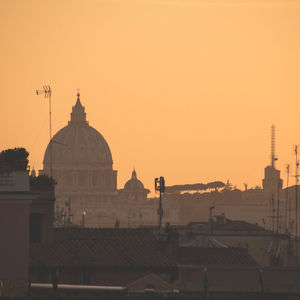 St peter basilica against clear sky during sunset