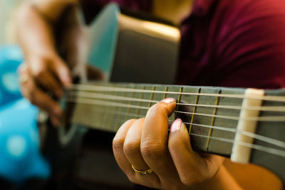 Cropped image of woman playing guitar