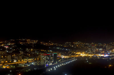 High angle view of illuminated buildings in city at night