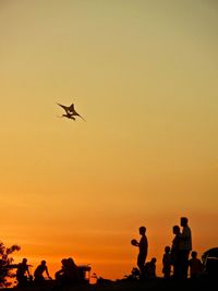 Low angle view of silhouette people against sky during sunset
