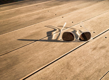 High angle view of shadow on wooden floor