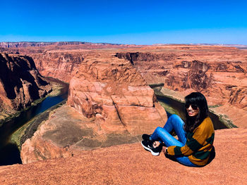 Woman sitting on rock