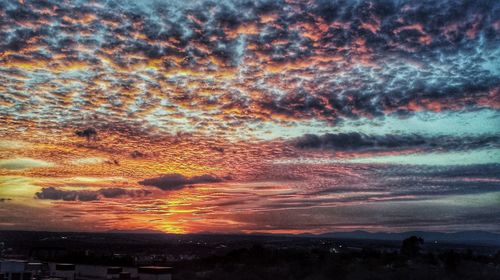 Scenic view of dramatic sky over city