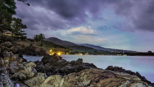 Scenic view of sea and mountains against sky