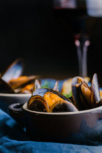 Delectable mussels with herbs in metal saucepan