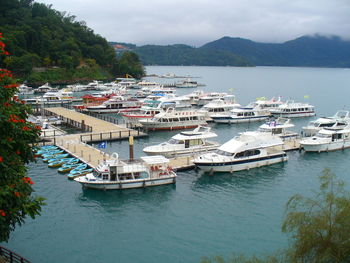 High angle view of boats moored in sea against sky