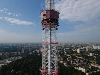 Communications tower and buildings against sky