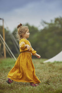 Side view of woman standing on field