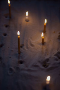 High angle view of lit candles