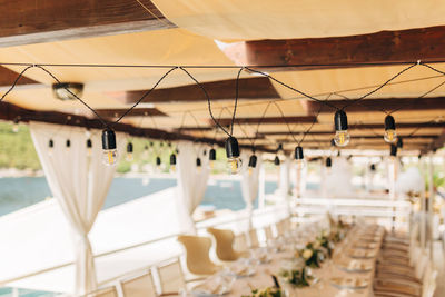 Row of light bulbs hanging on table at restaurant