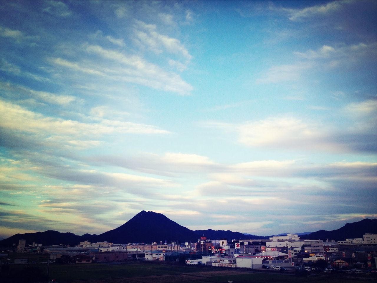 sky, mountain, building exterior, cloud - sky, architecture, built structure, transportation, cloud, cloudy, mode of transport, house, scenics, car, town, beauty in nature, mountain range, nature, nautical vessel, outdoors, sea