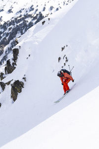 Man skiing downhill on pyrenees mountain, catalonia, spain