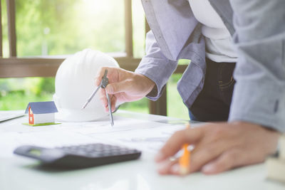 Midsection of man working on table