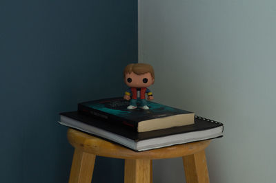 Close-up of toys on table against wall