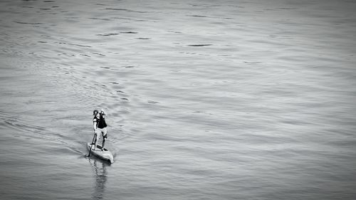 High angle view of man paddleboarding in sea