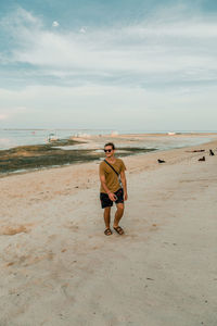 Full length of man on beach against sky