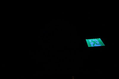 Close-up of illuminated lamp over black background