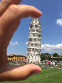Midsection of people in city against sky