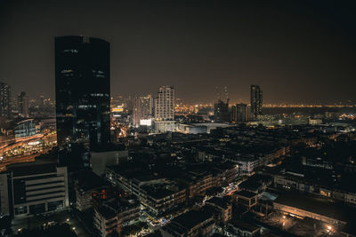 High angle view of illuminated buildings against sky at night