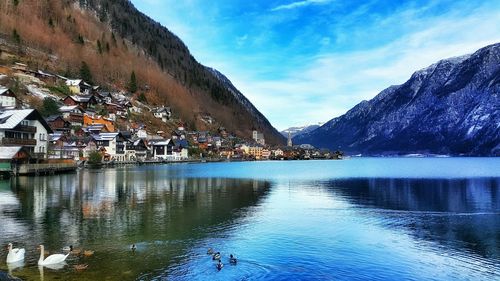 Scenic view of lake by mountain against sky