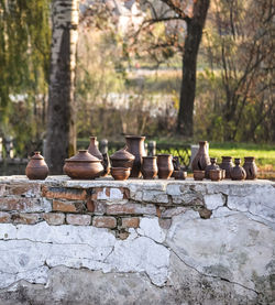 Pottery, clay pots standing on an old brick in the park in the afternoon