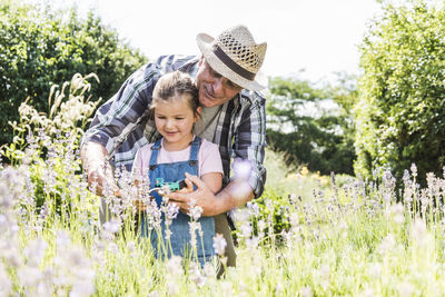 Grandfather and granddaughter in lavender field