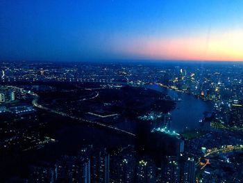 Aerial view of illuminated buildings in city at night