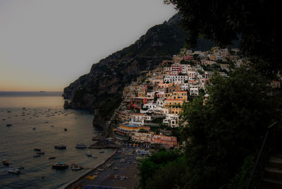 High angle view of buildings by sea against sky in positano